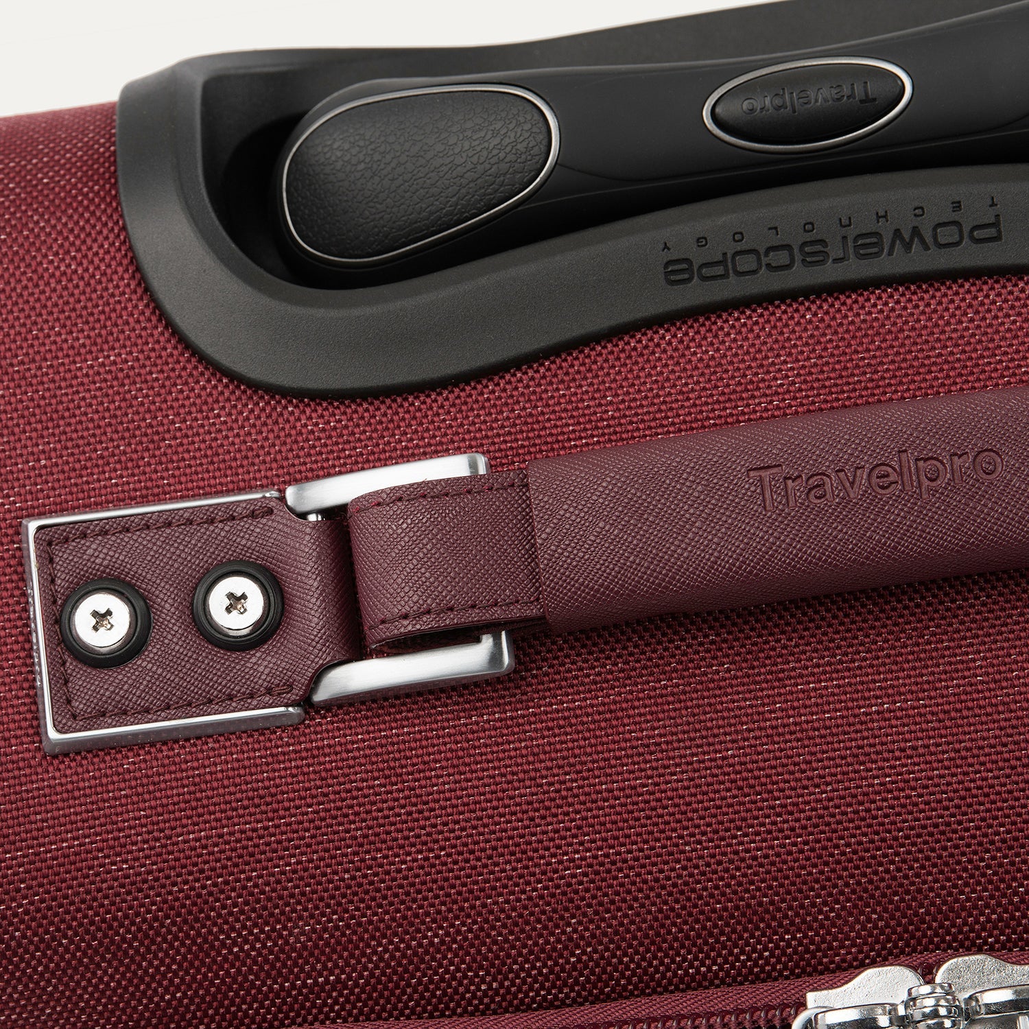 Close-up of a red suitcase handle