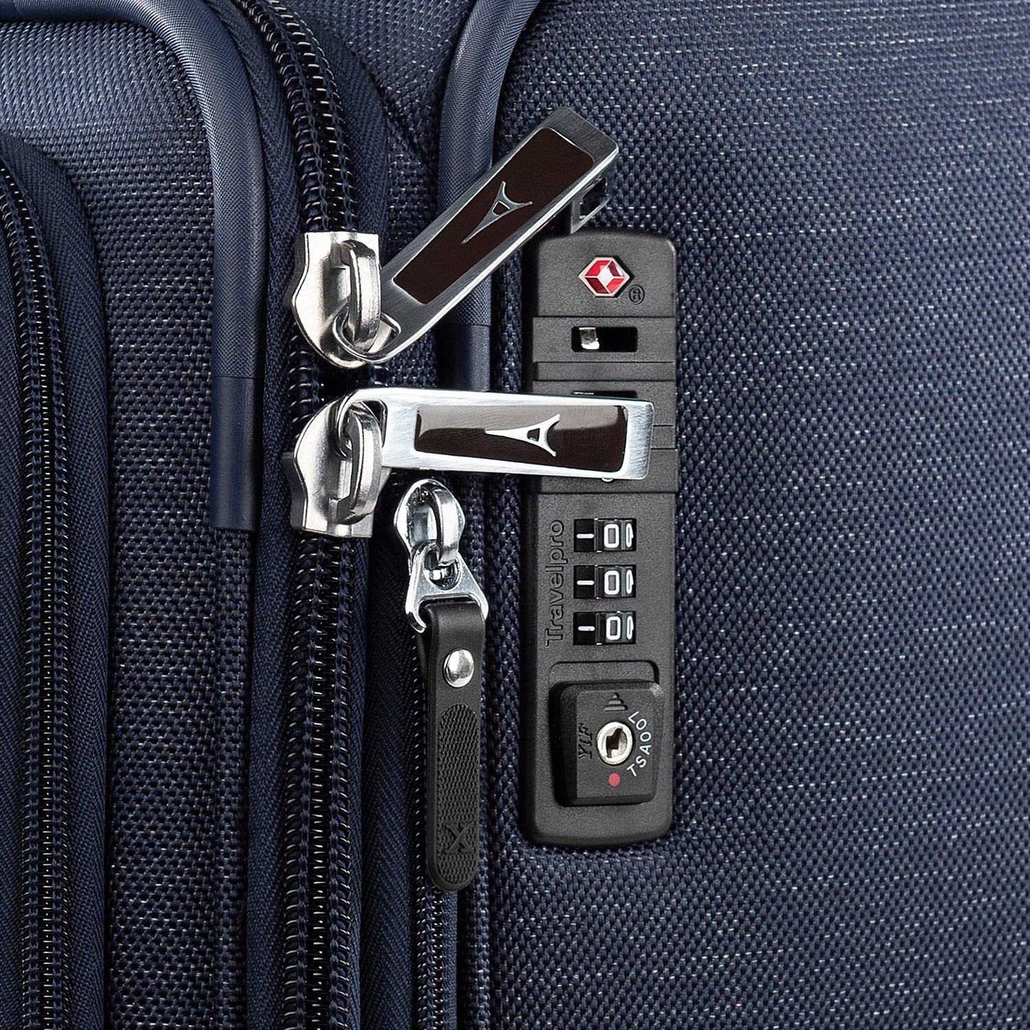 Close-up of a suitcase's lock and zipper mechanism.