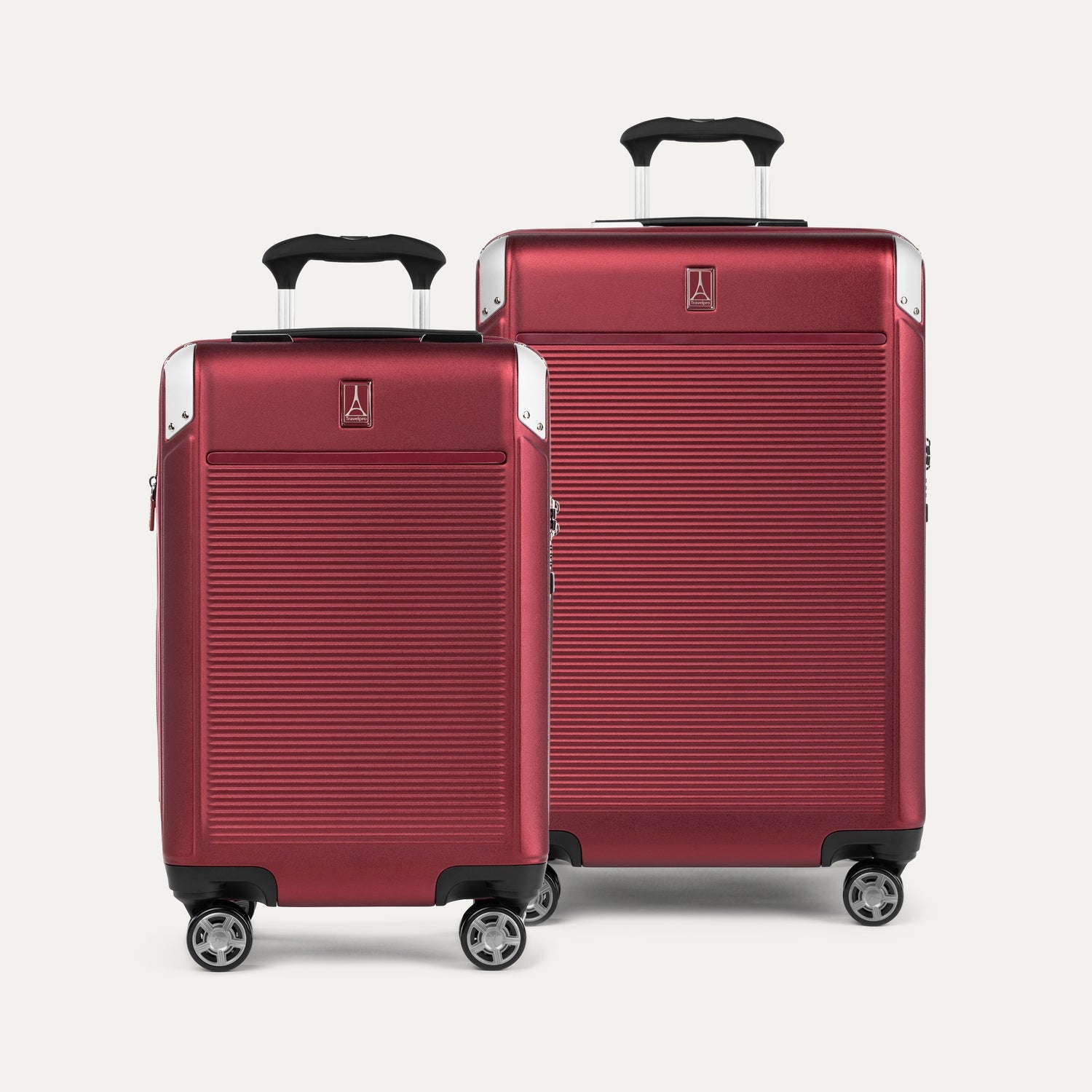 A set of two red hardside spinner suitcases, one carry-on and one medium check-in size, with the Travelpross logo on the top.