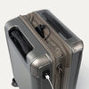 Close-up of a metallic sand suitcase with a power bank and USB cable.