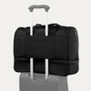 Green weekender bag with rear strap on a white background