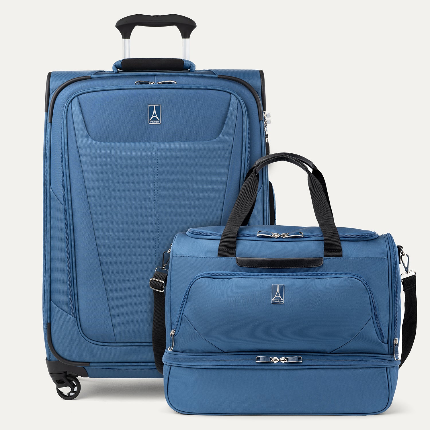 Blue suitcase and weekender bag on a white background