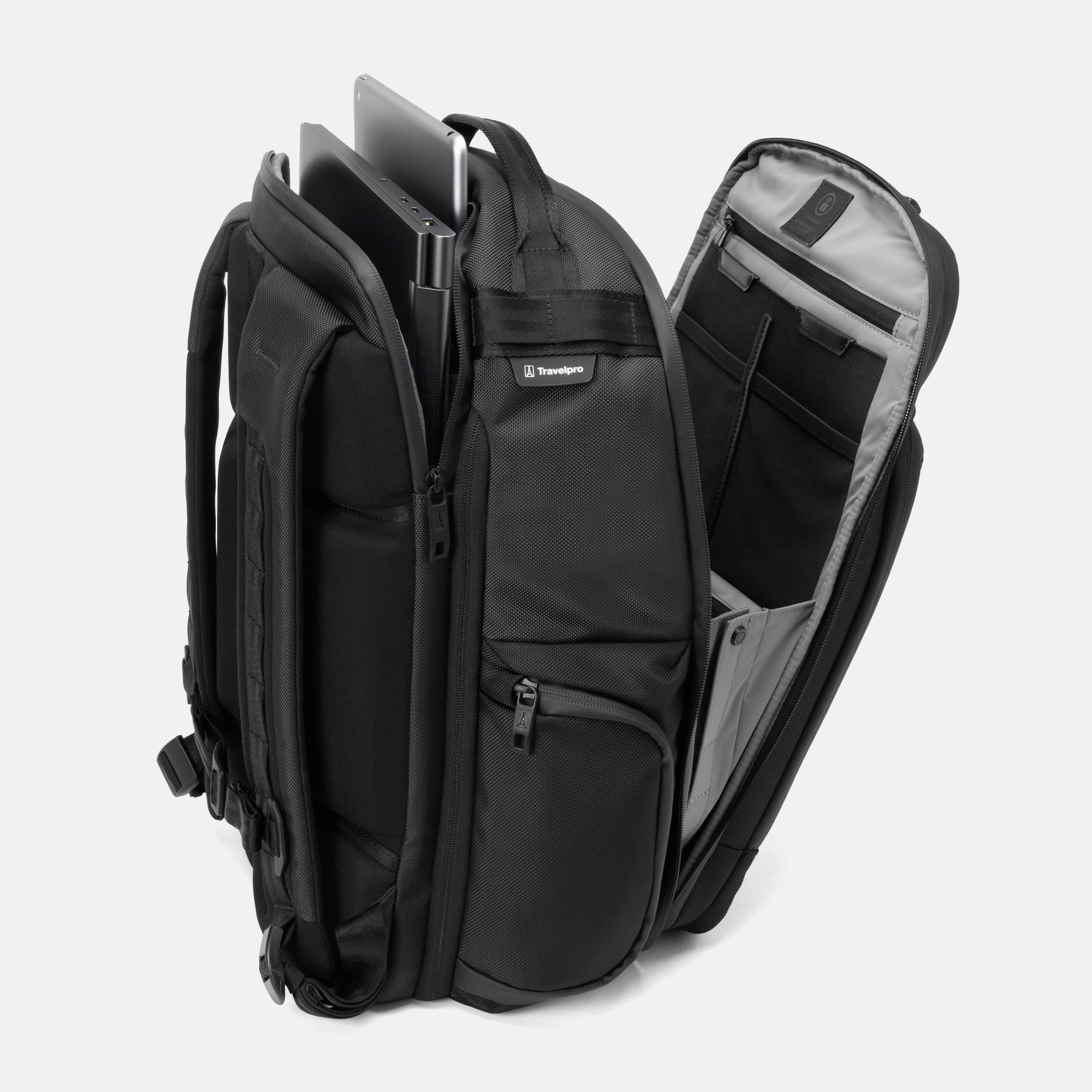 Black backpack with tech compartments open, showing laptop and tablet inside on a white background