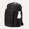 Black backpack with a white bottle inside on a white background