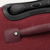 Close-up of a red suitcase handle