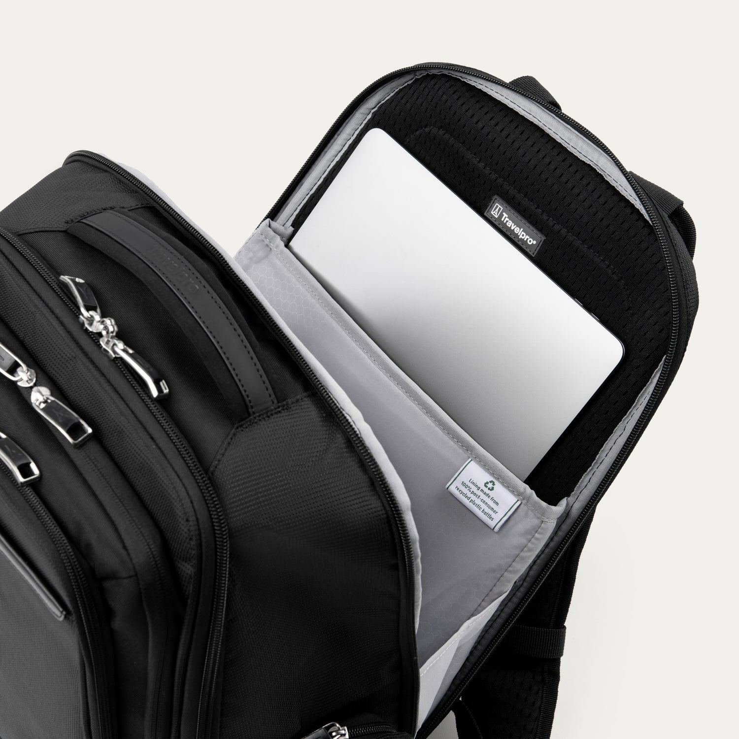 Black backpack laptop sleeve compartment open on a white background