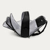 Black backpack with all the compartments open on a white background