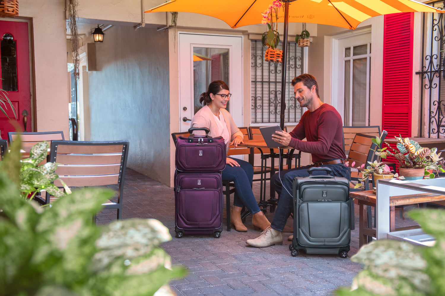 Man and woman with Travelpross spinner suitcase and carry on luggage set