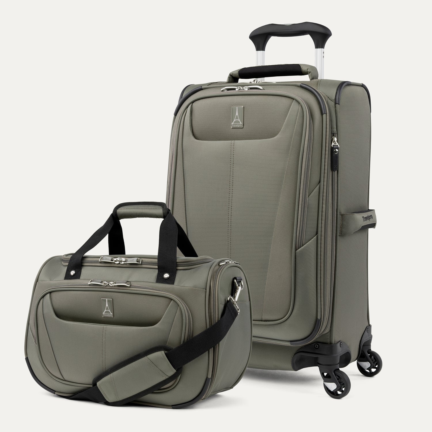 Green suitcase and tote with black handles and wheels on a white background