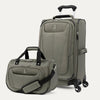 Green suitcase and tote with black handles and wheels on a white background