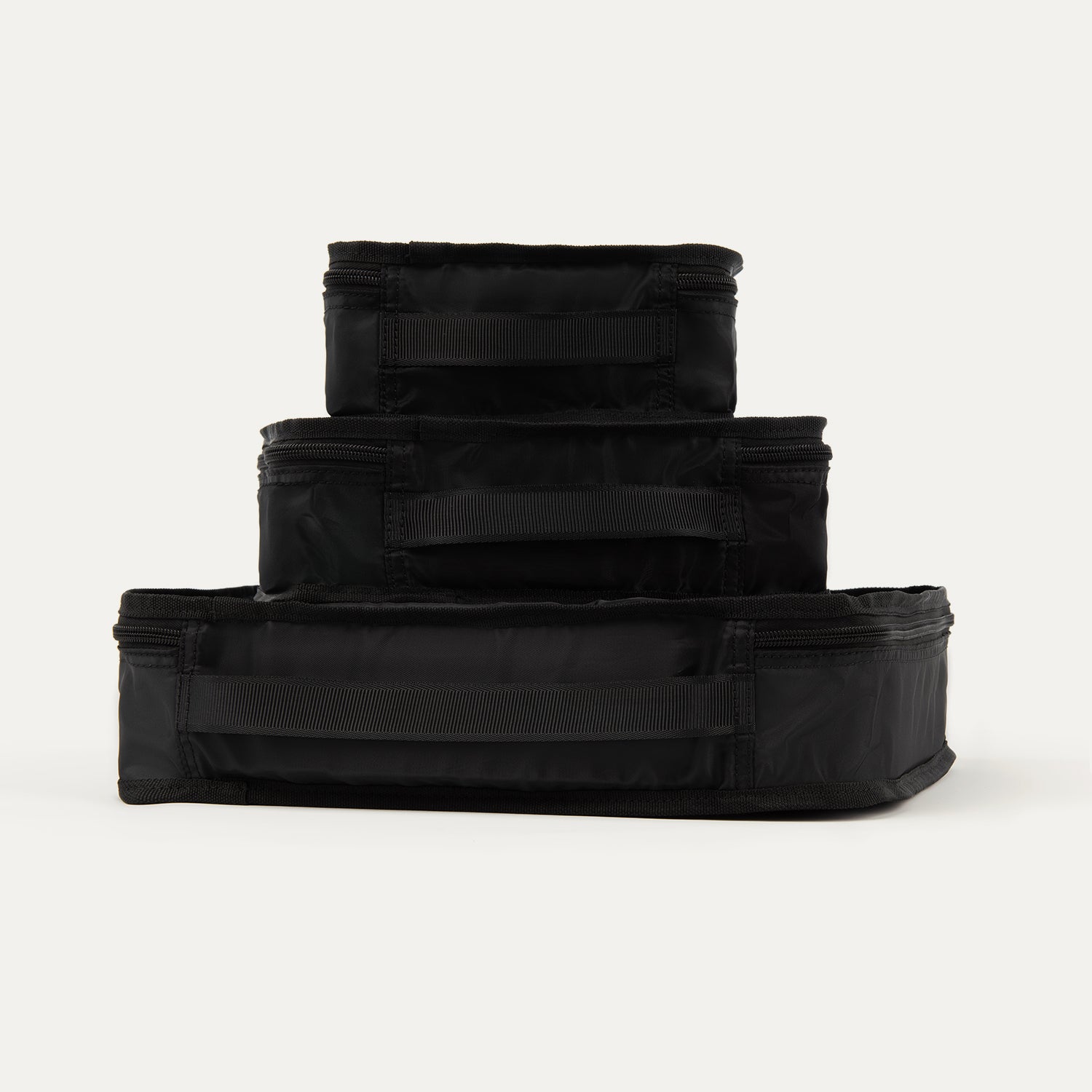 Rear view of Travelpross Essentials 3 Pack Packing Cube Set (S/M/L) in BLACK, stacked to show integrated grab handles.
