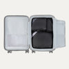 Top view of Travelpross Essentials 3 Pack Packing Cube Set in BLACK, efficiently arranged inside an open hardside carry-on.