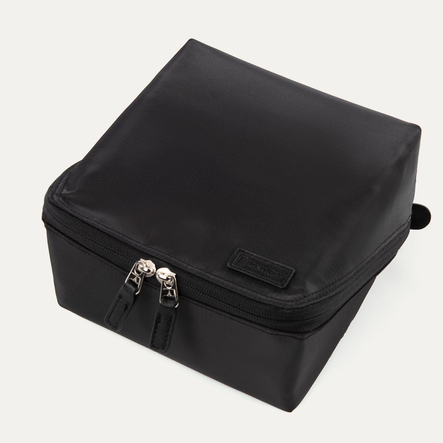 Top view of the MaxAccess Cubes™ Deluxe Hanging Toiletry Organizer in black, showing its dual zippers and a Travelpross logo patch on the front