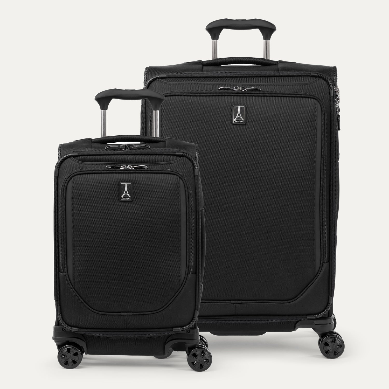 A set of two black spinner suitcases, one carry-on size and one check-in size on a white background 