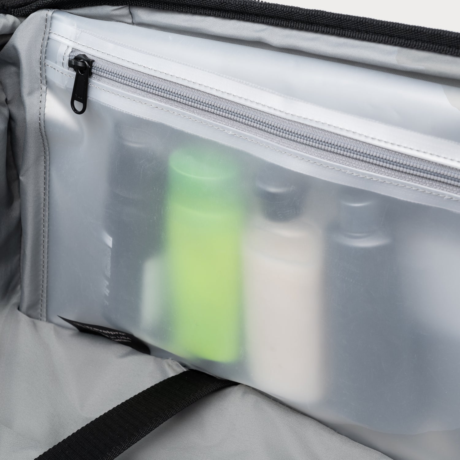Clear pouch with cosmetic bottles inside, showing a close-up of the product arrangement.