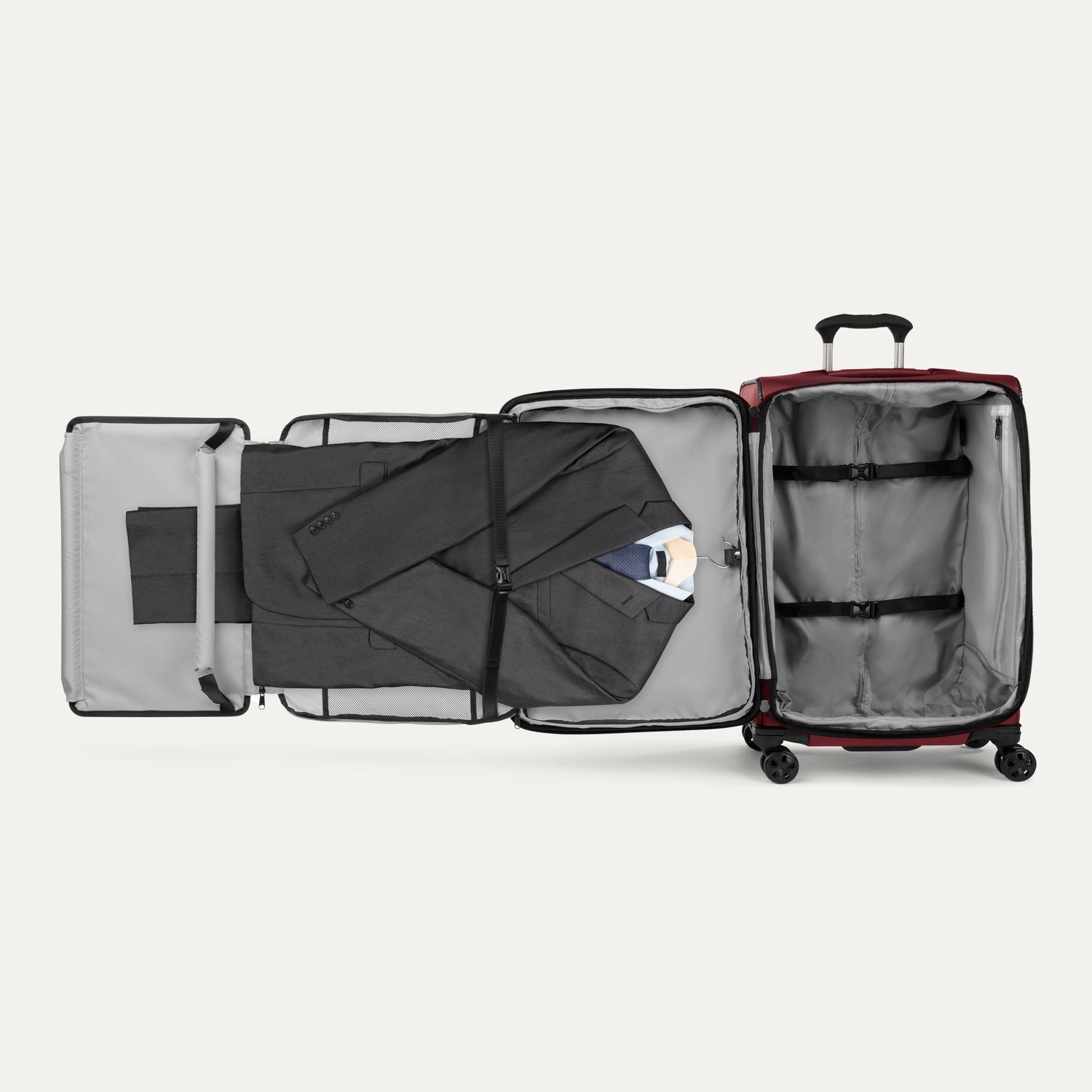 Open suitcase with fold out suiter and clothes on a white background