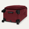 Red suitcase with black wheels on a white background