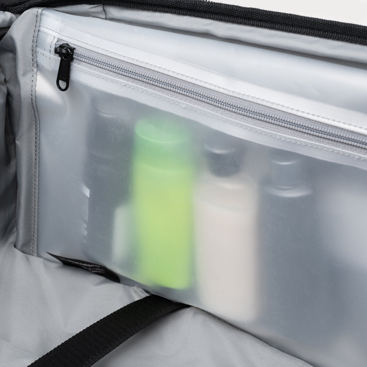 Close-up shot of toiletries inside a clear pouch, showing organized layout.