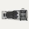 Open suitcase with suit displayed in fold out suiter compartment on white background