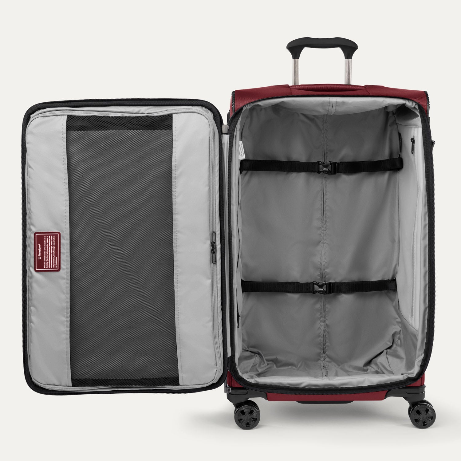 Interior view of Crew™ Classic Spinner in Rosewood Red, featuring adjustable compression straps and a zippered mesh divider.