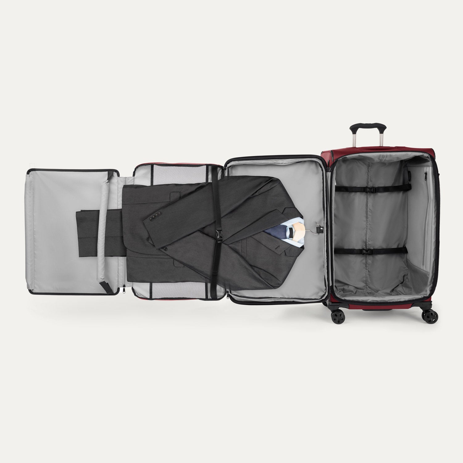 Interior view of the Crew™ Classic Large Check-In Spinner in Rosewood Red, shown with suiter system fully extended and clothing neatly packed.
