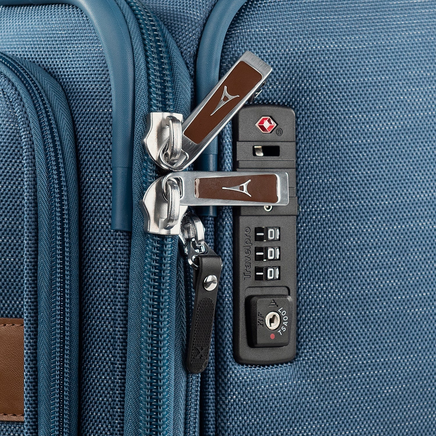 Close-up of a blue suitcase with zipper combination lock.
