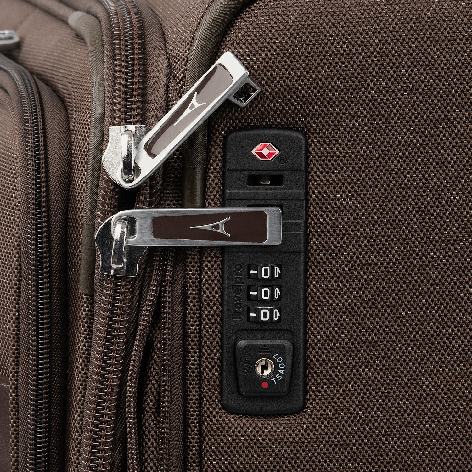 Close-up of a suitcase lock on a brown suitcase.