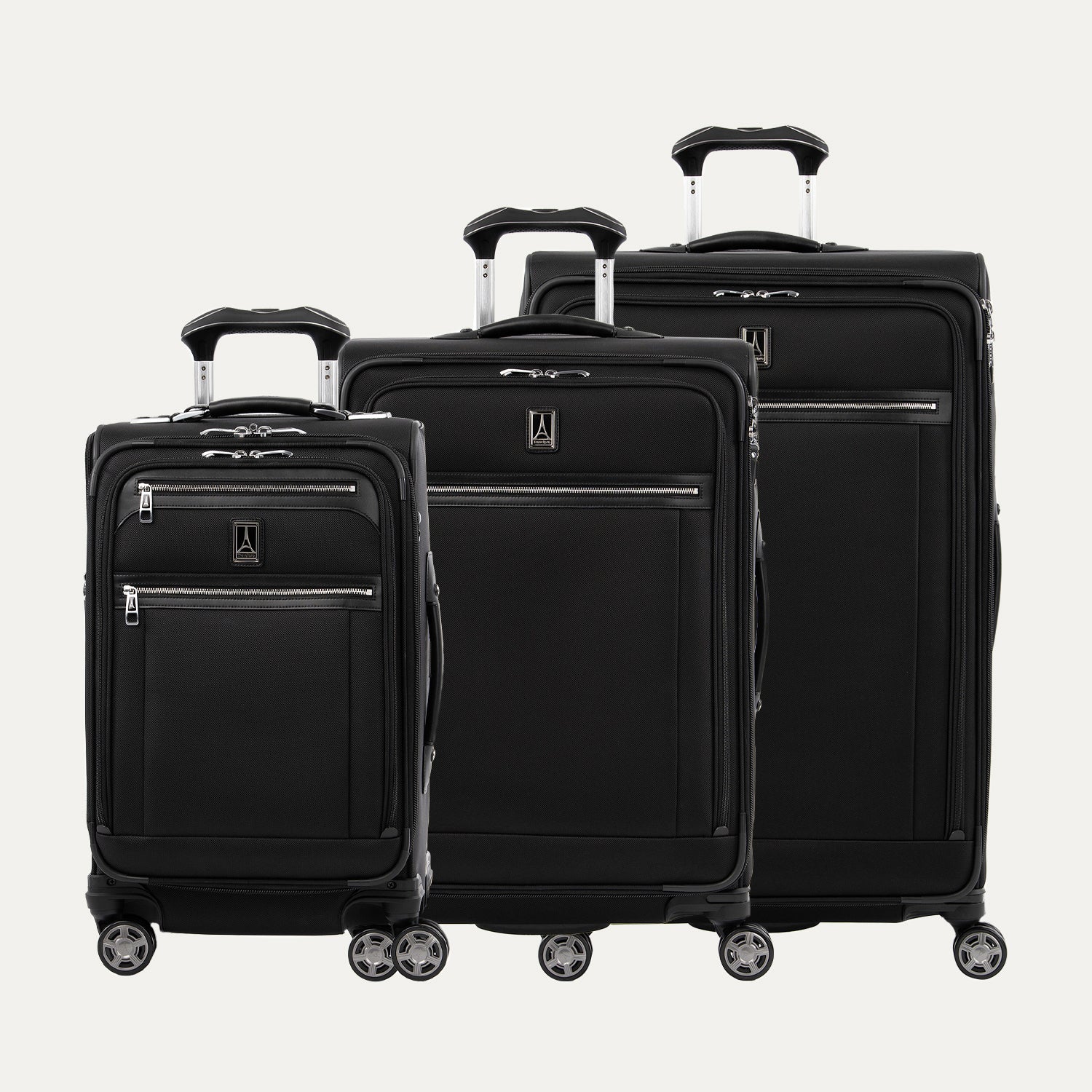 Set of three black suitcases of different sizes on a white background