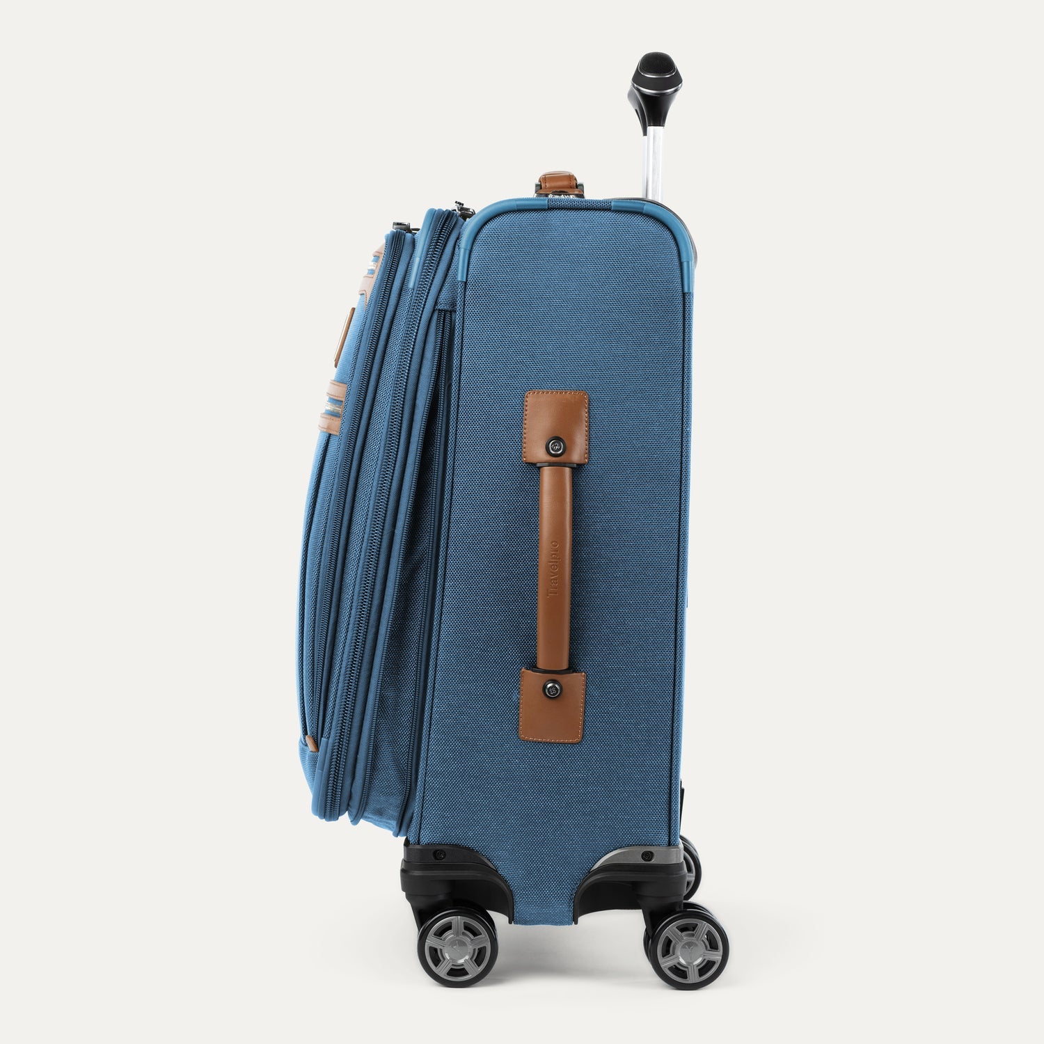 Side view of blue suitcase with brown side handle on a white background
