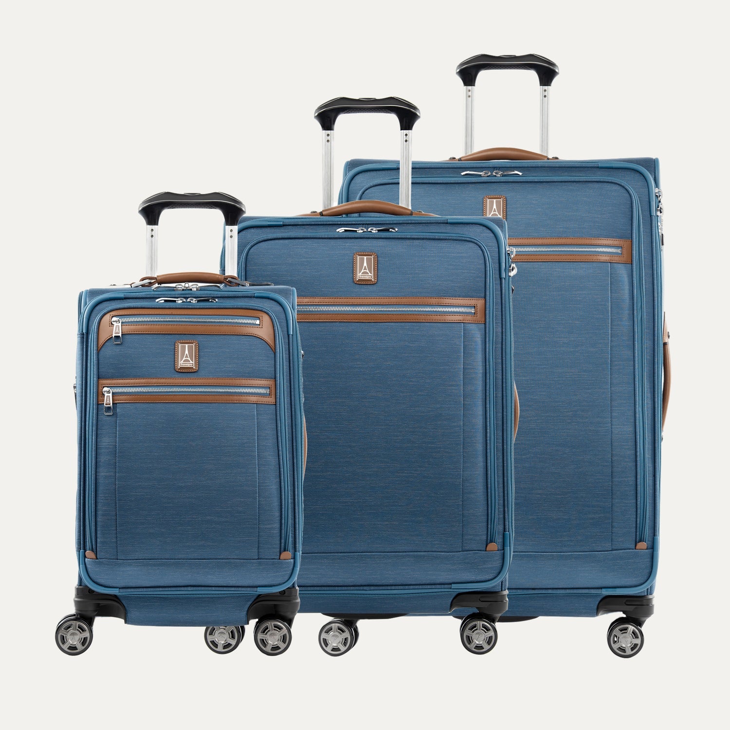 Set of three blue suitcases with brown accents on a white background