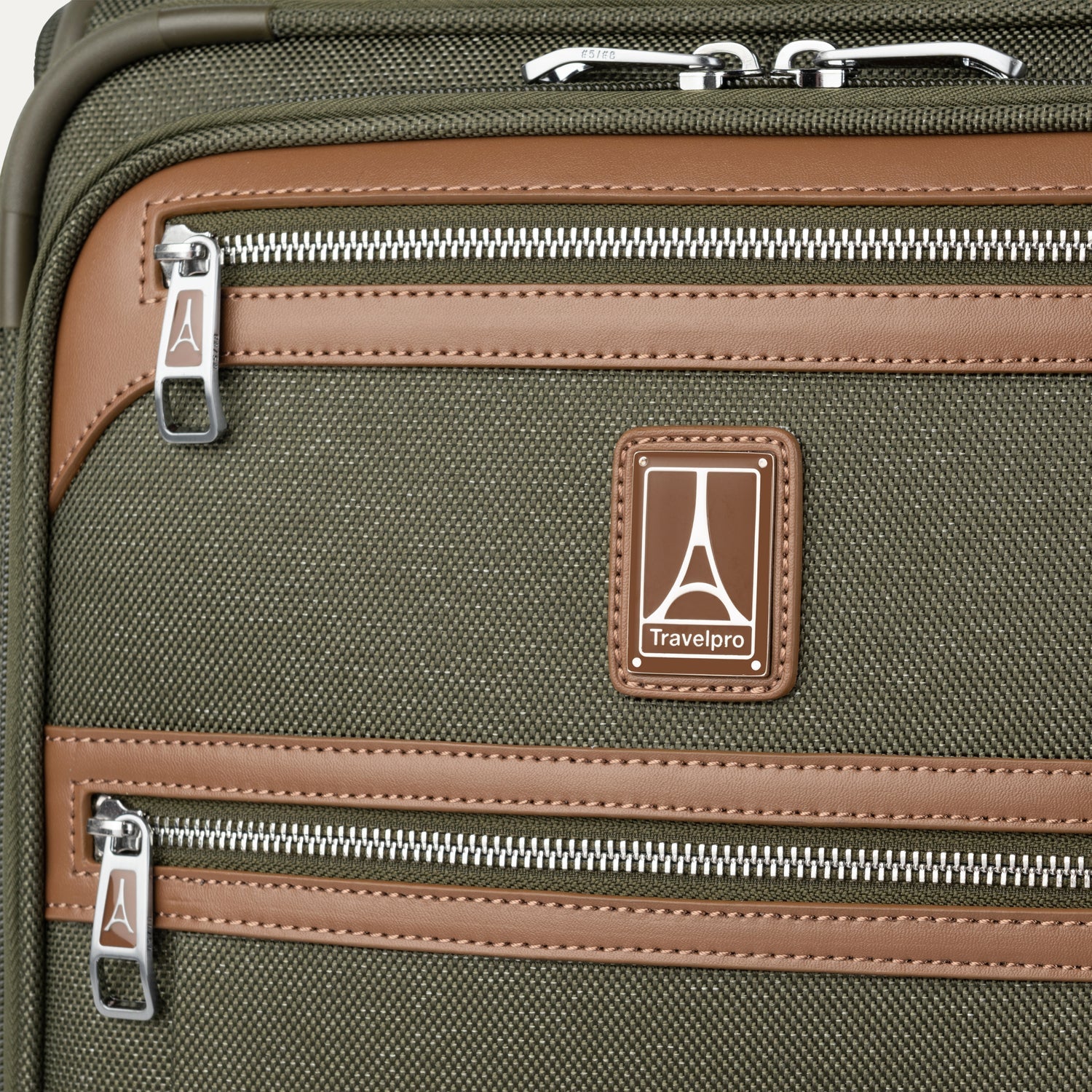 Close-up of a green suitcase with zippers and Travelpross logo.