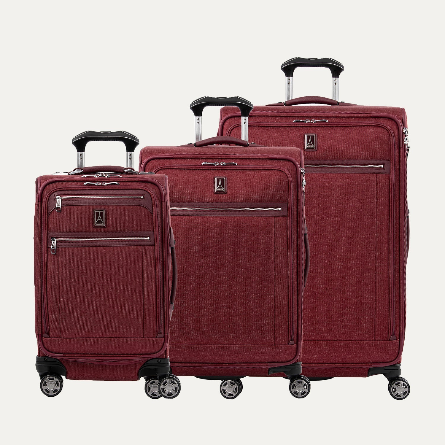 Set of three red suitcases on a white background