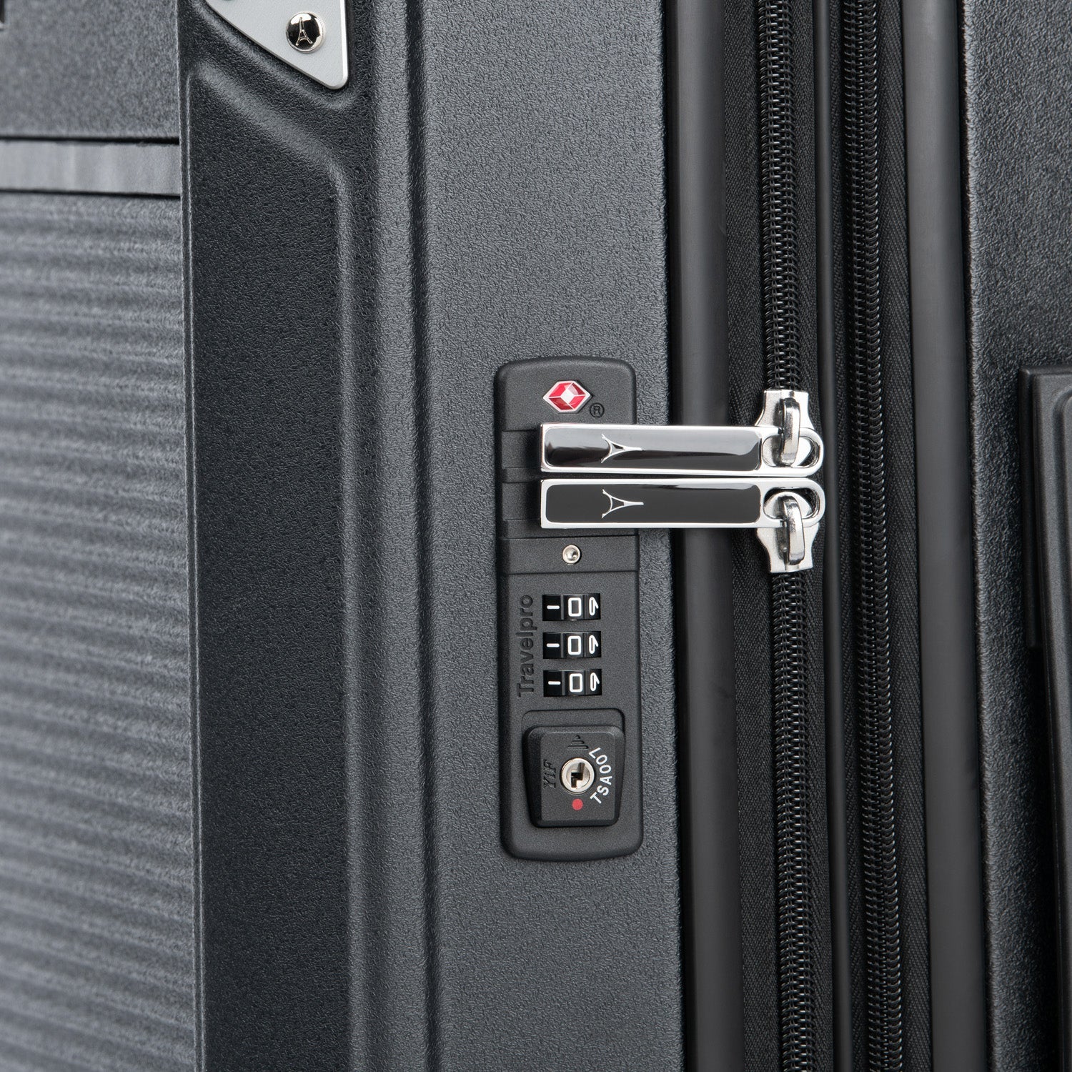 Close-up of a suitcase's combination lock and zipper.