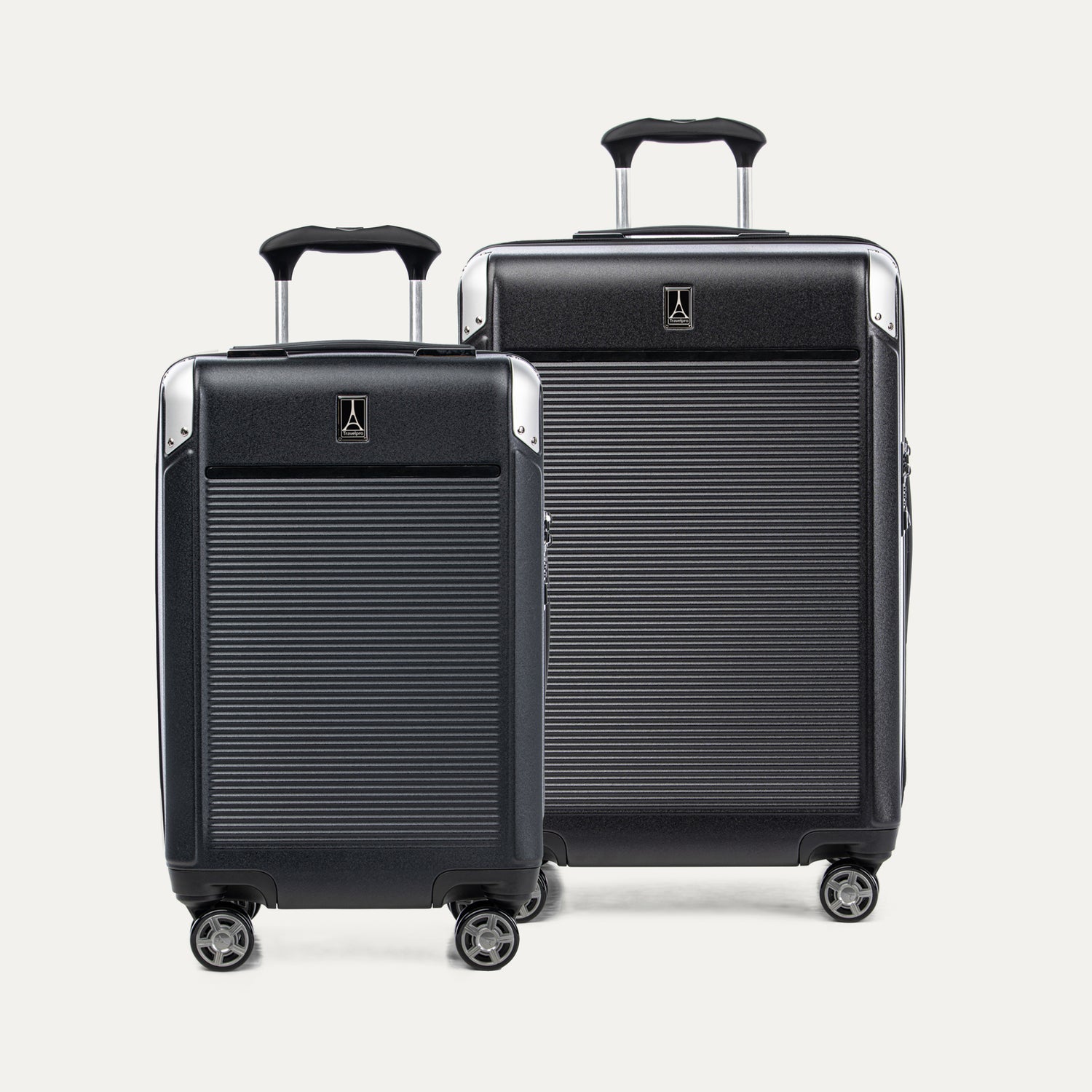 A set of two black hardside spinner suitcases, one carry-on size and one medium check-in size, with the Travelpross logo on the top.