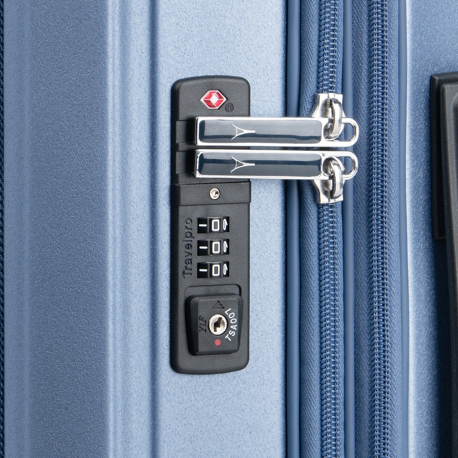 Close-up of a suitcase lock on a blue suitcase.