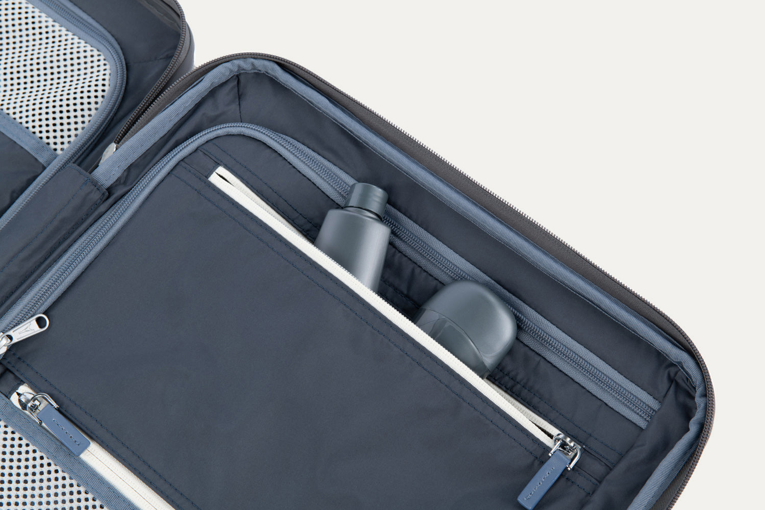 Organized interior of a suitcase with compartments and accessories.