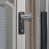 Close-up of a suitcase lock on a silver suitcase.