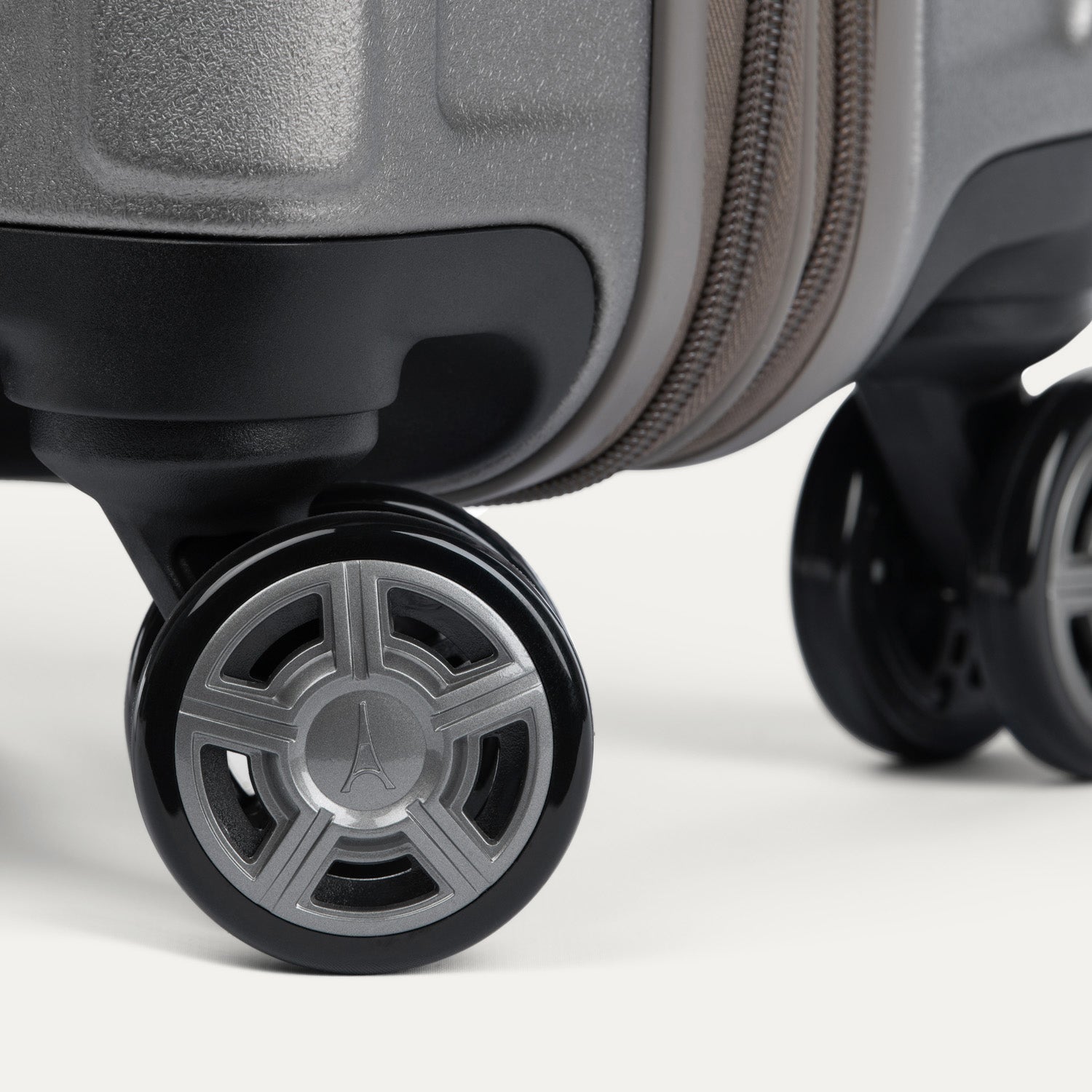 Close-up of suitcase wheels on a white background