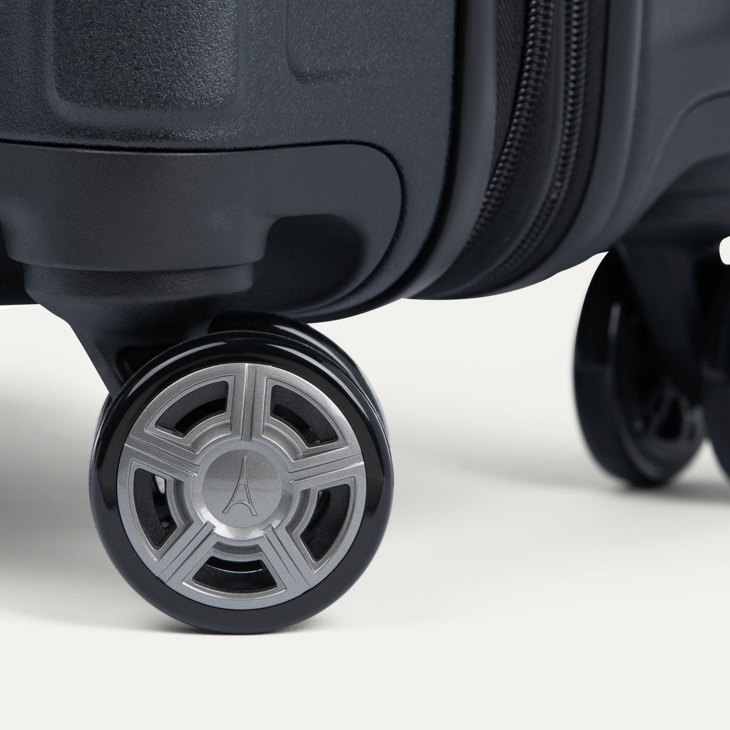 Close-up of a suitcase wheel with a Travelpross logo on a white background