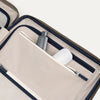 Interior view of Travelpross Platinum Elite  Hardside Spinner in Metallic Sand, showing zippered pocket with visible travel-size toiletries