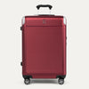 Front view of Travelpross Platinum® Elite Hardside Medium Check-In Expandable Spinner in Daring Red, featuring textured polycarbonate shell with chrome corner guards.
