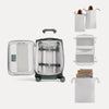 Open suitcase with travel accessories on a white background