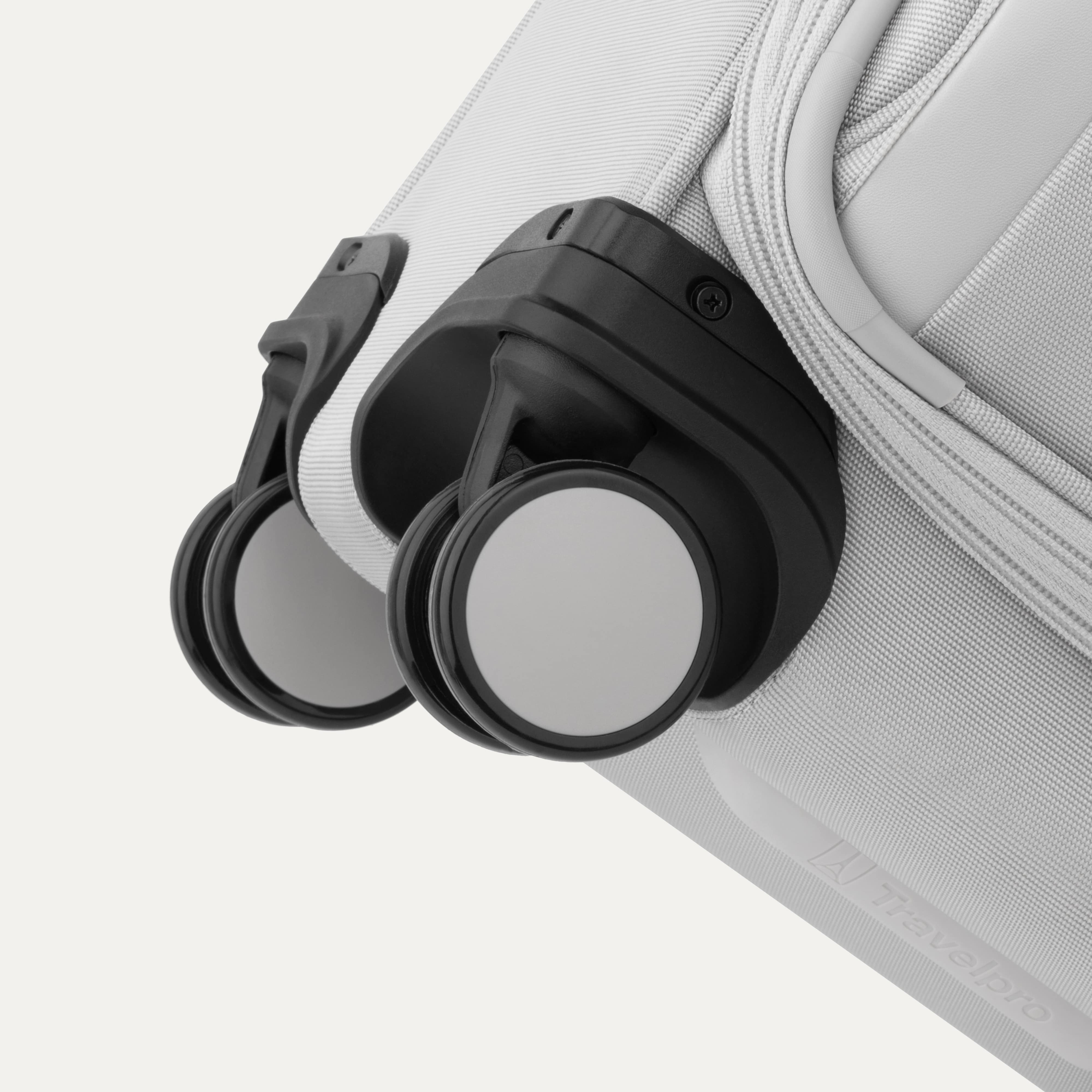 Close-up of a gray suitcase with black wheels on a white background