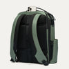 Green and black backpack with a phone on top against a white background