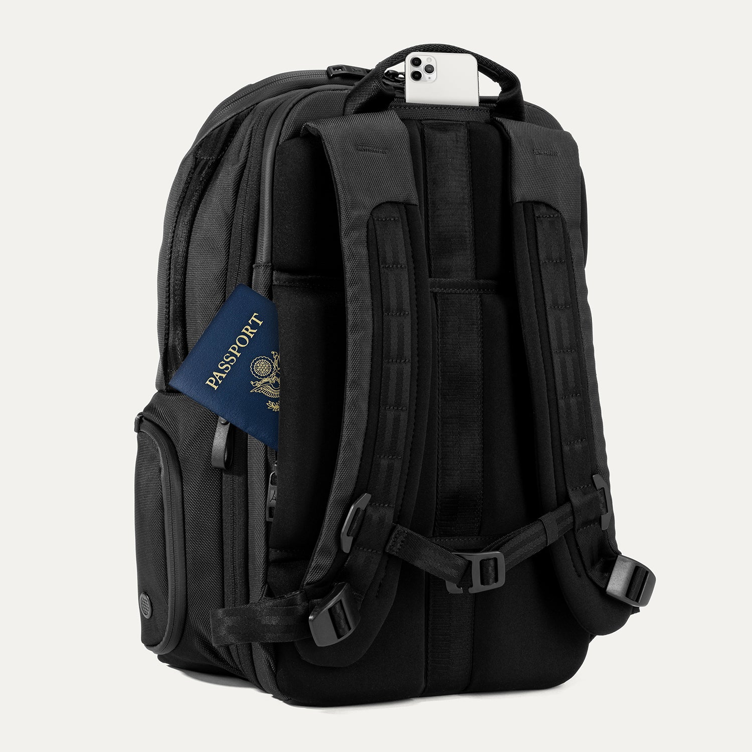 Rear view of Travelpross Altitude All-Purpose Laptop Backpack in Jet Black, featuring padded straps and QuickSlip Pocket with phone.
