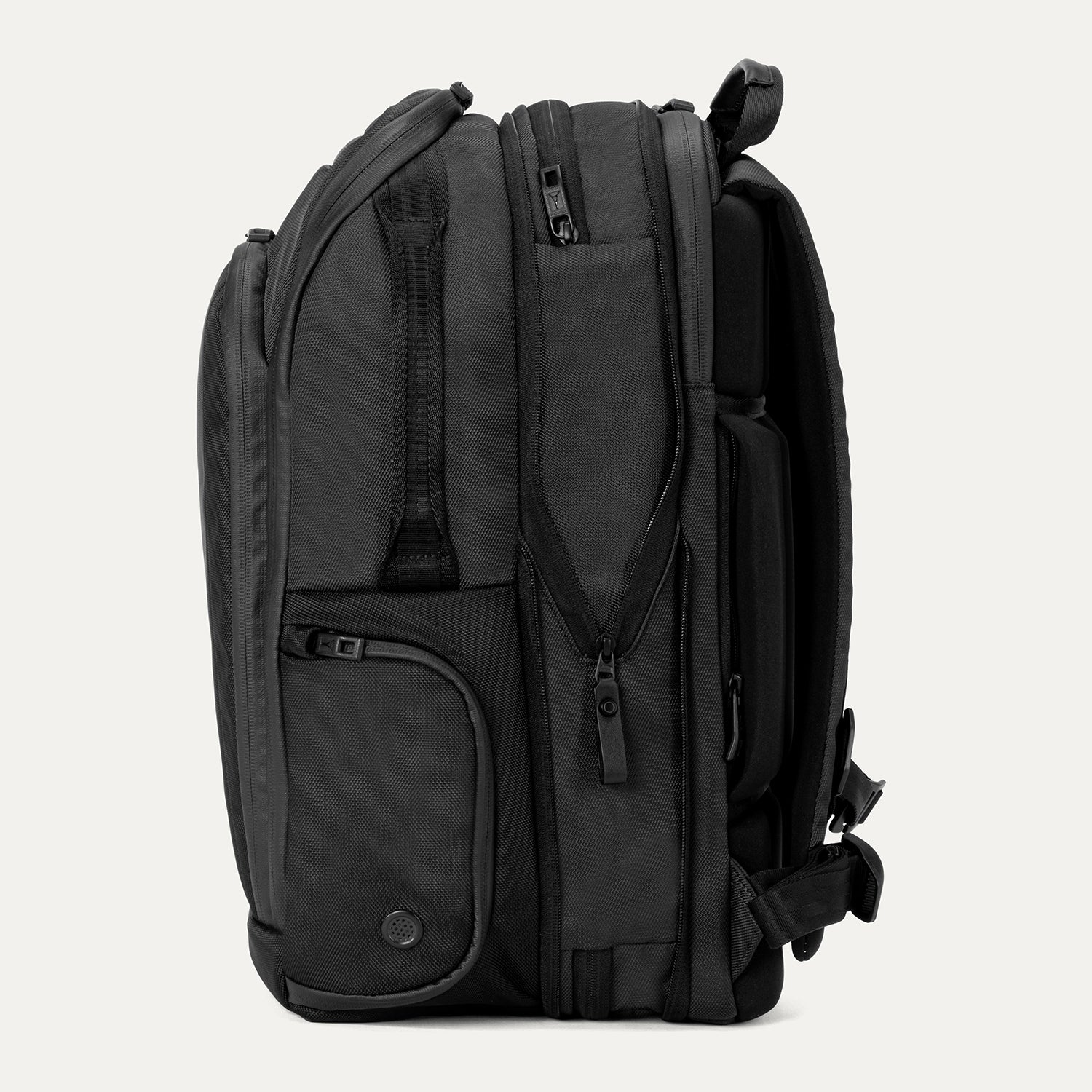 Expanded side view of Travelpross Altitude All-Purpose Laptop Backpack in Jet Black, showing zippered compartments and external gear pocket.
