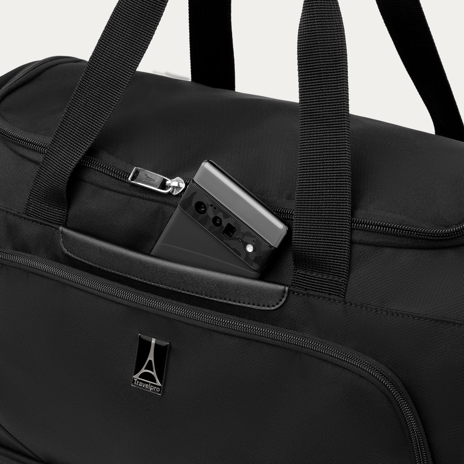 Black weekender with phone in QuickSlip™ pocket, featuring the Travelpross logo