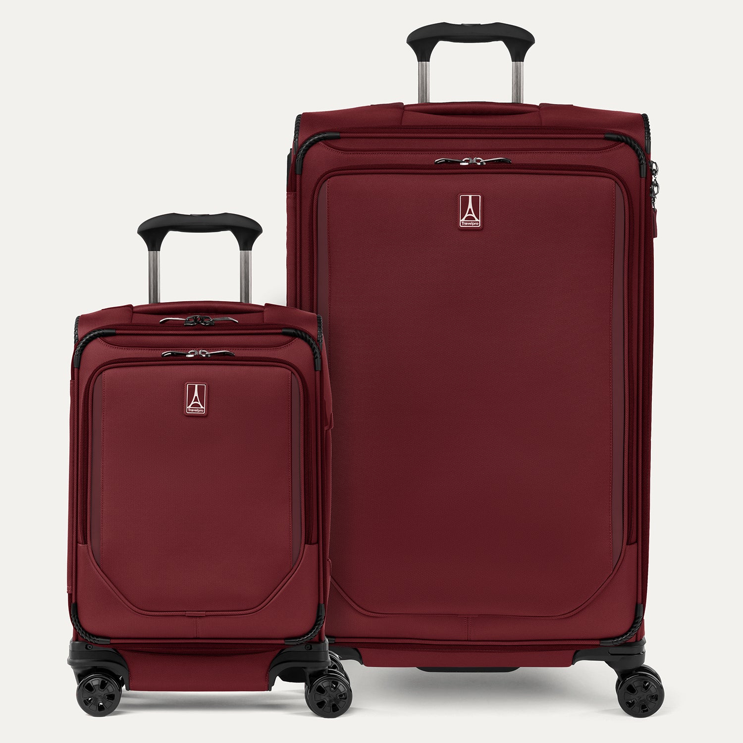 A set of two red spinner suitcases, one carry-on and one large check-in size, with the Travelpross logo visible on them.
