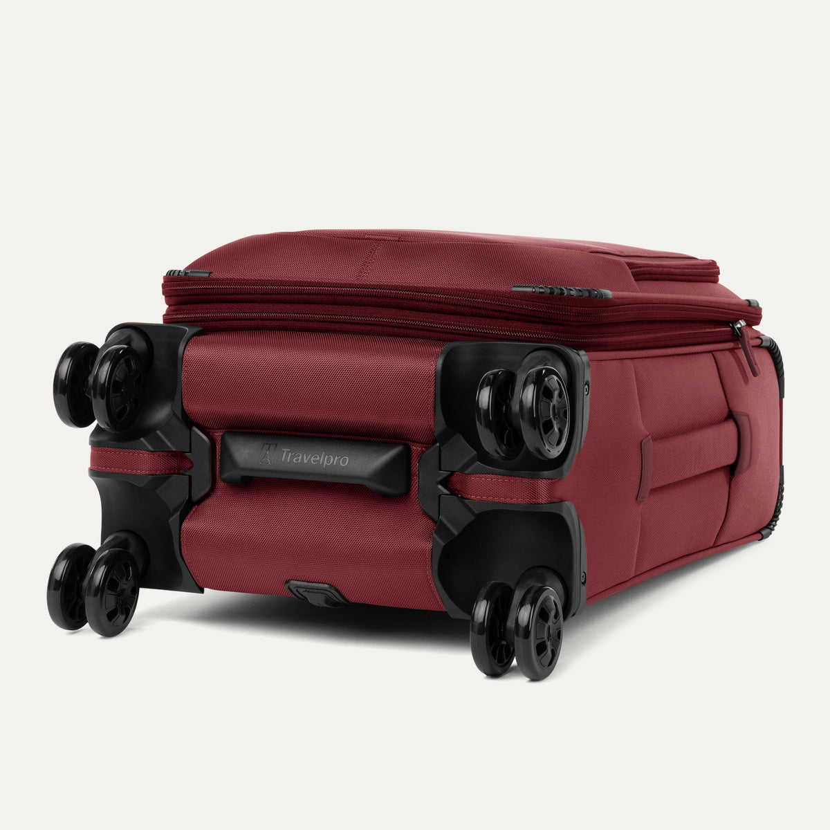 Red suitcase with black wheels on a white background
