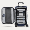 Open navy suitcase with organized contents on a white background
